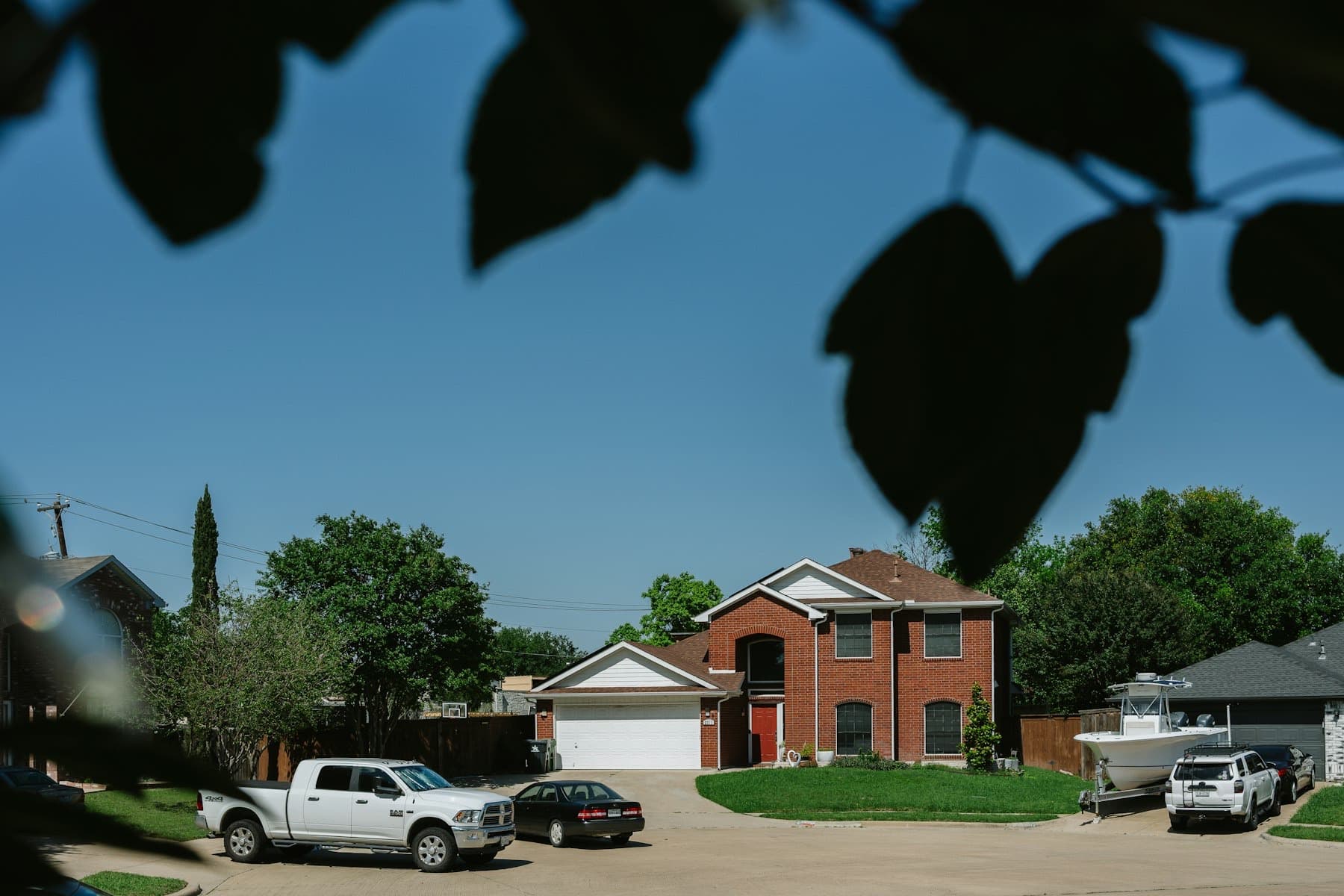 Two-story brick home with a white double garage door