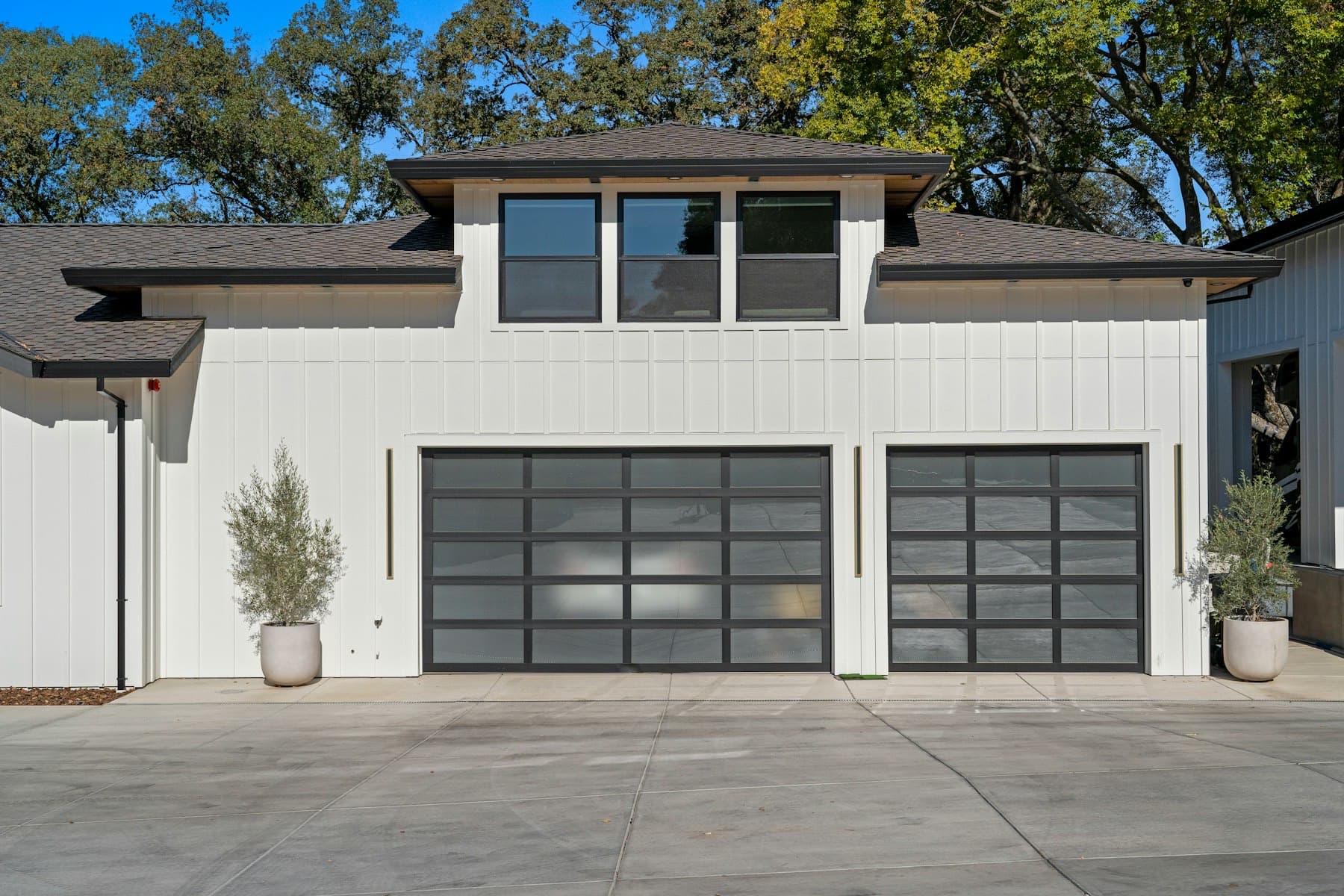 Two black garage doors on a modern home